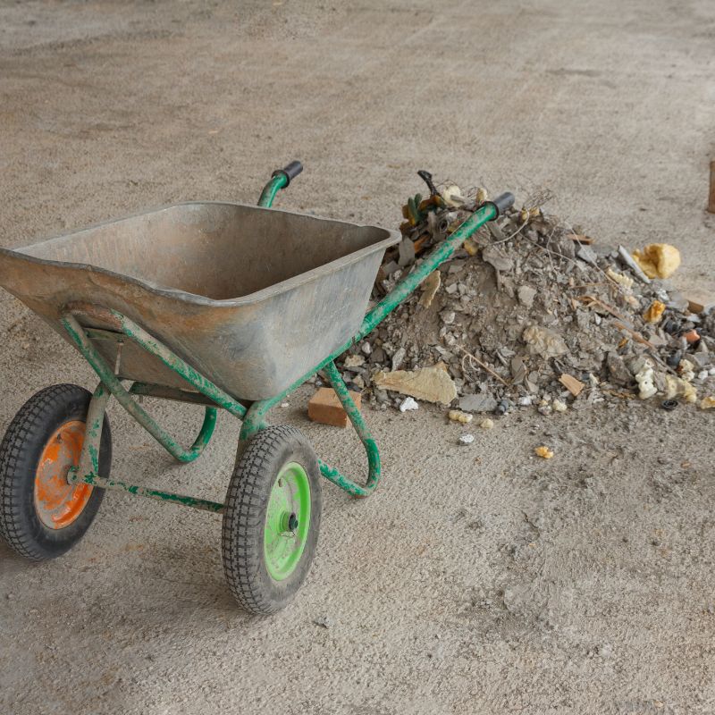 wheelbarrow next to pile of construction debris to clean up and haul away in San Antonio